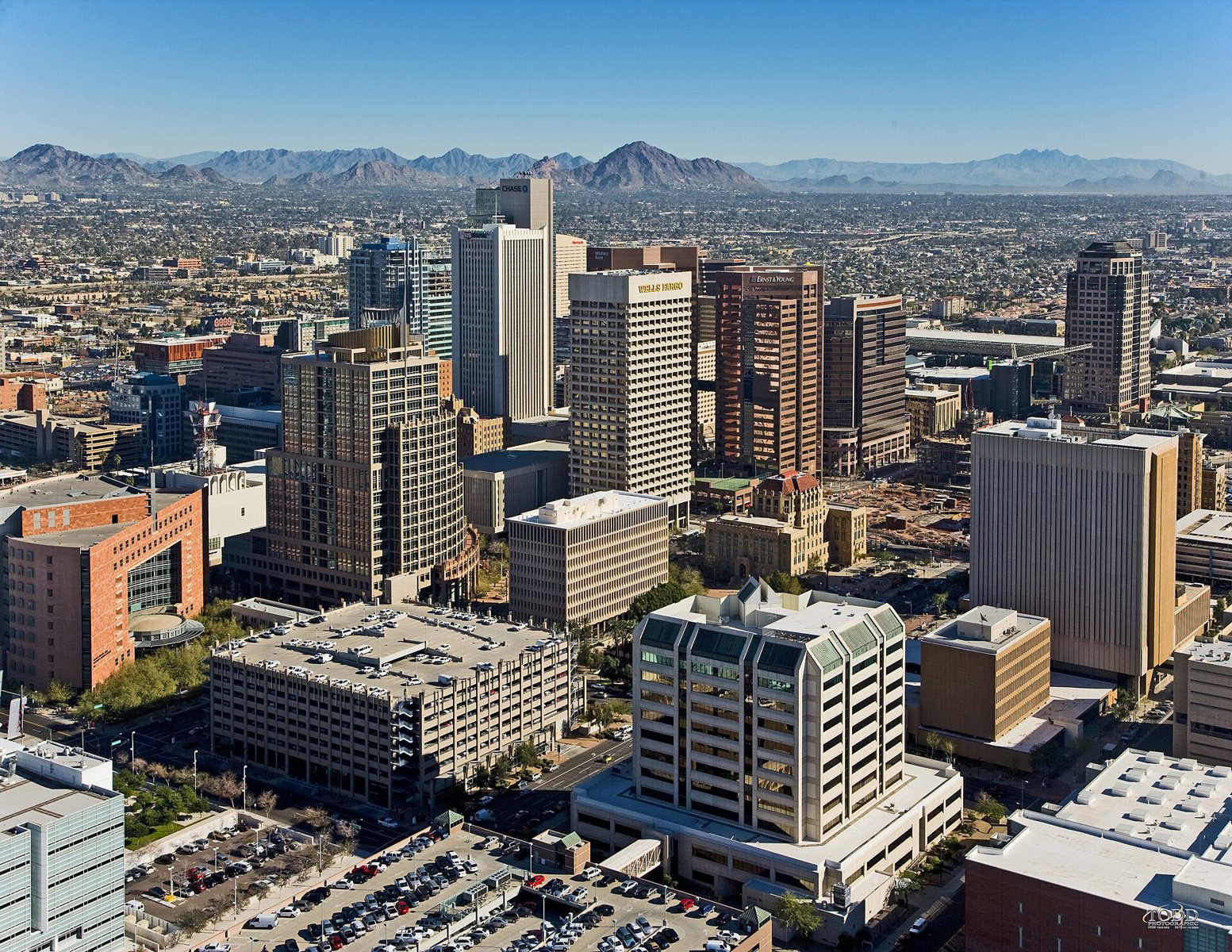 Skyline view of Phoenix — looking northeast from a helicopter, from above the 4th Avenue Jail. 
Foreground is the Central City Village and Central Avenue Corridor of Downtown Phoenix.
In the foreground Municipal and County Courts are visibl